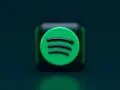 Ikona Spotify na ciemnozielonym tle.
